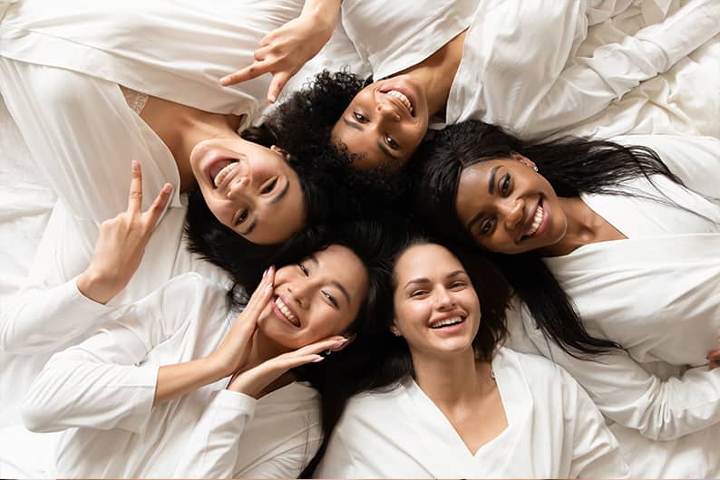 Women with clean flawless faces smiling