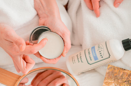 Women applying all natural salve and goat milk lotion to hands
