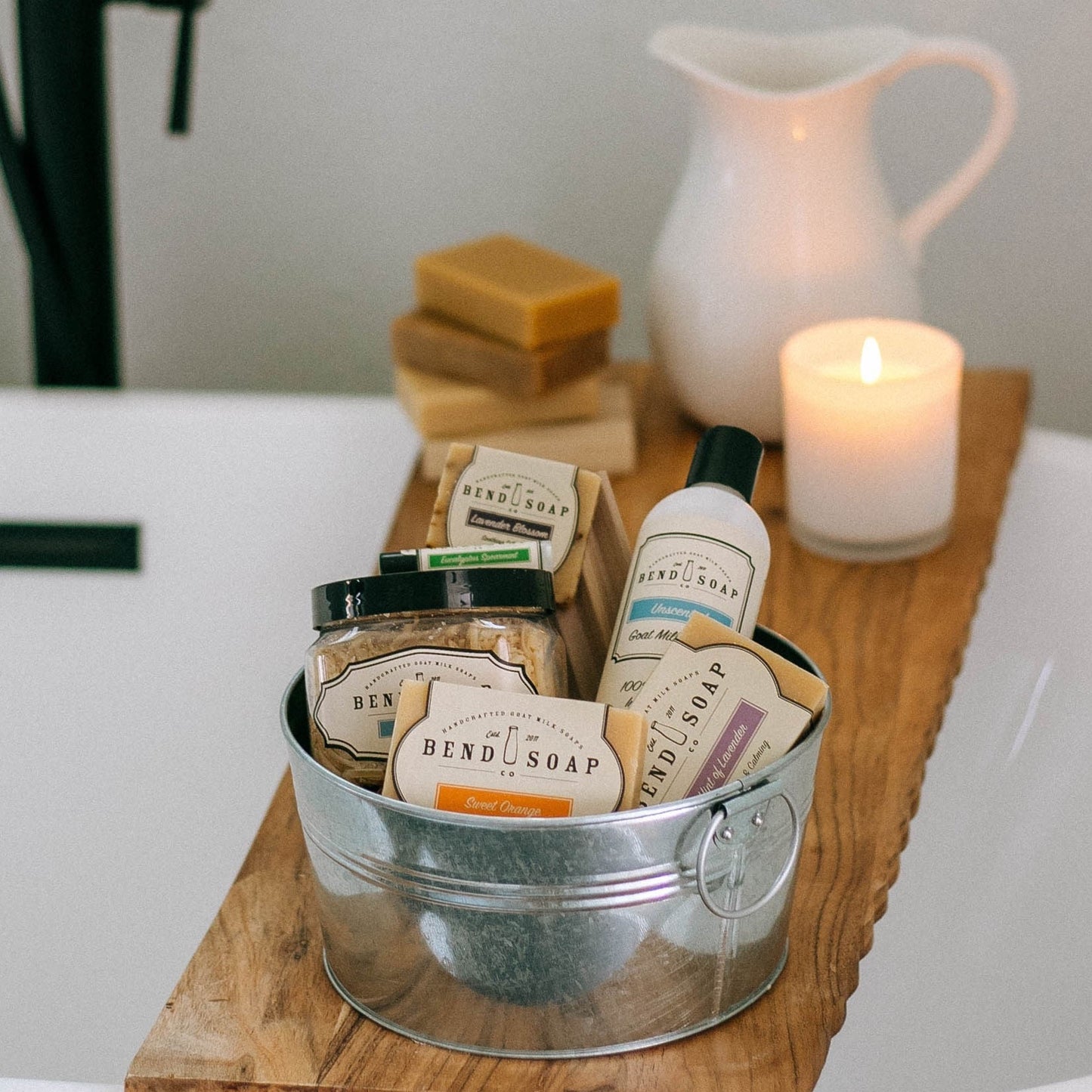 The Experience Gift Set in silver tin over bathtub with candle