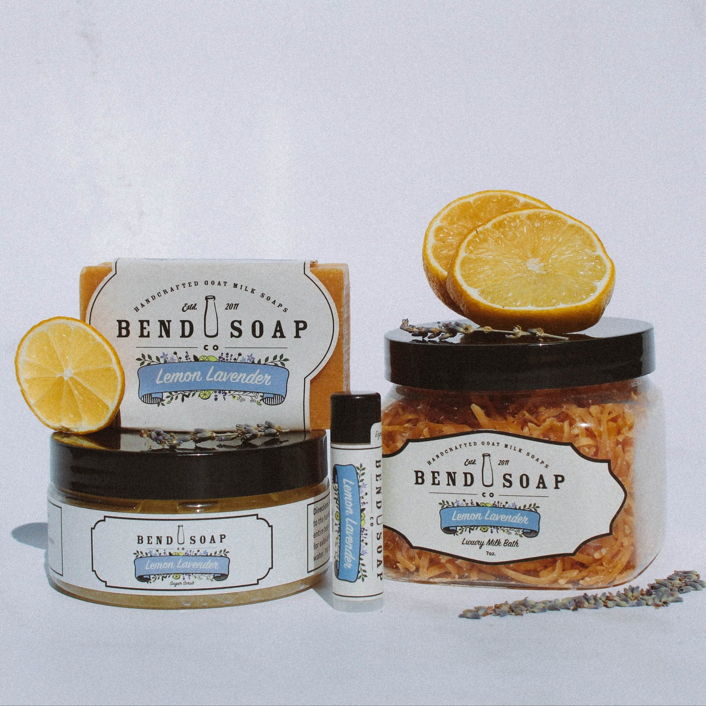The Lemon Lavender Collection features Bend Soap Company's soap, lotion, lip balm, bath shreds, and sugar scrub in the Lemon Lavender scent, beautifully arranged with lemons and lavender for the ultimate skincare bundle.