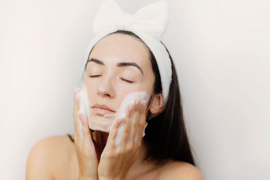 Woman gently cleansing her face with a foaming cleanser, demonstrating a gentle cleanser for sensitive skin routine
