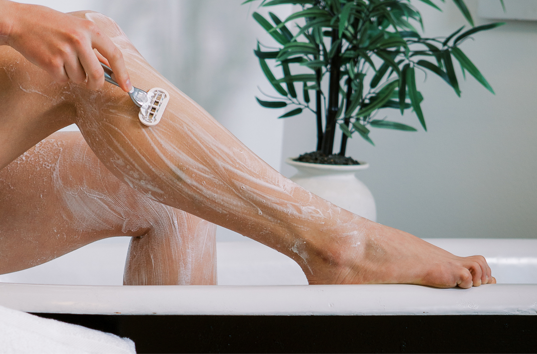 woman shaving her legs with goat milk soap