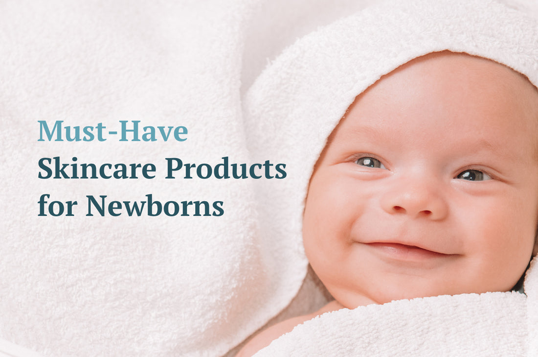 Smiling newborn baby wrapped in towels 