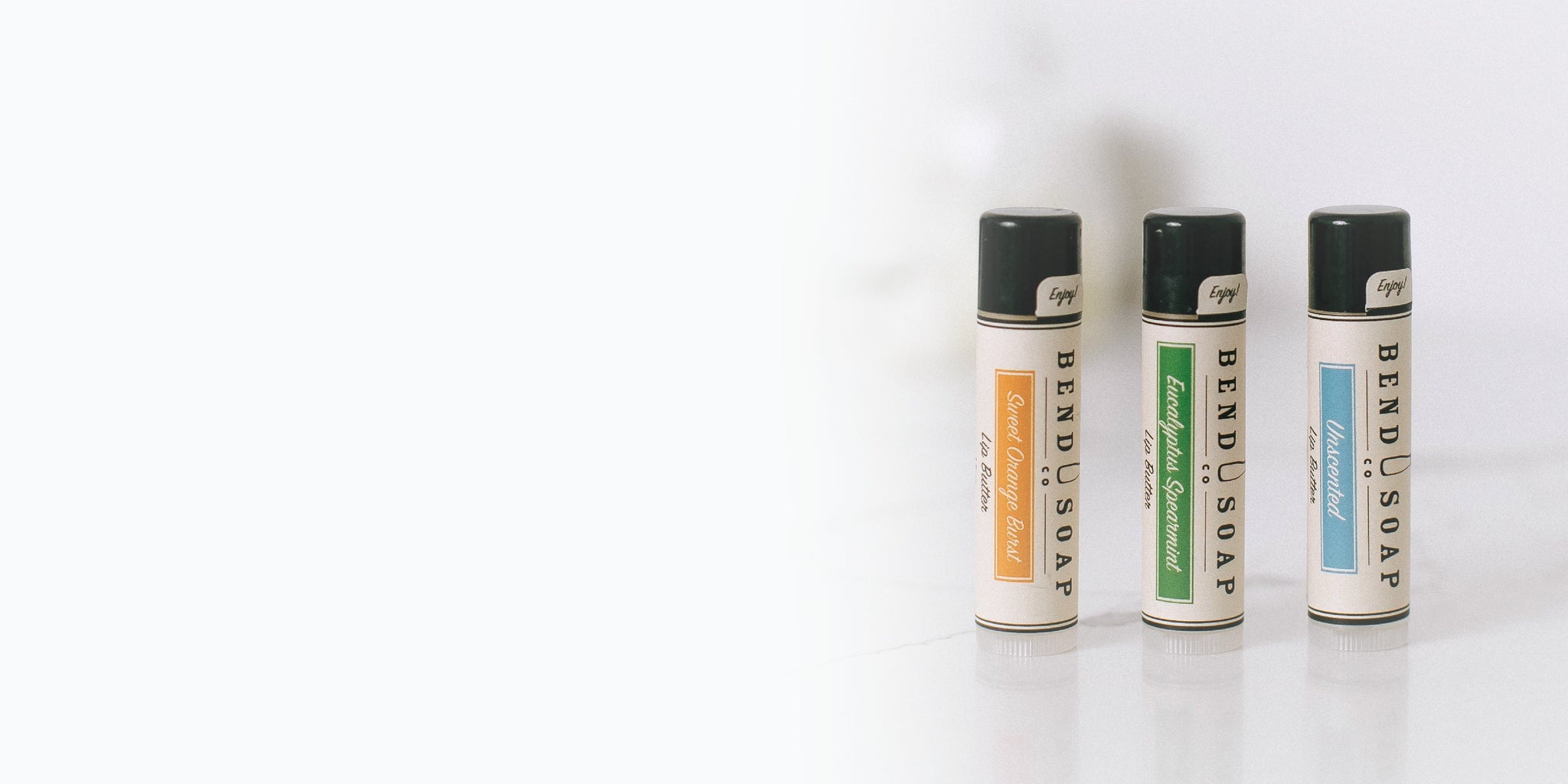 Women holding a tube of all-natural unscented lip butter