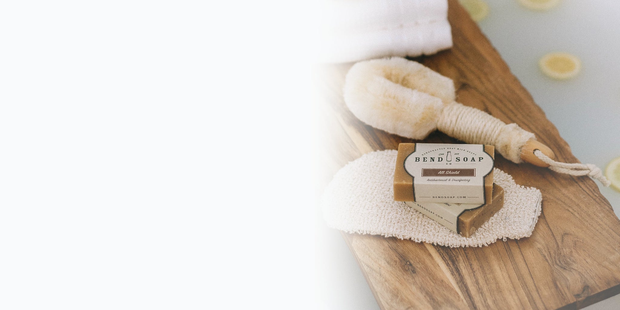 Wood Soap Brush, Lotion Dispenser, Soap Rack and Other Bath Accessories on Light Background