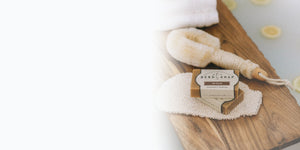 Wood Soap Brush, Lotion Dispenser, Soap Rack and Other Bath Accessories on Light Background
