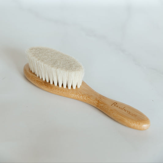 Wooden brush with bristle head on a white background