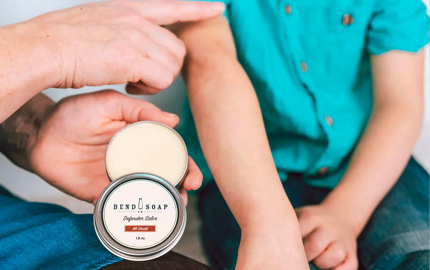 Woman applies All-Natural and Antimicrobial Salve to Her Son's Arm 