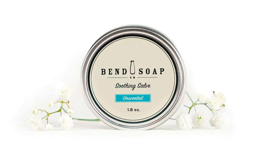 All-natural Unscented Soothing Salve with white flowers on a white background