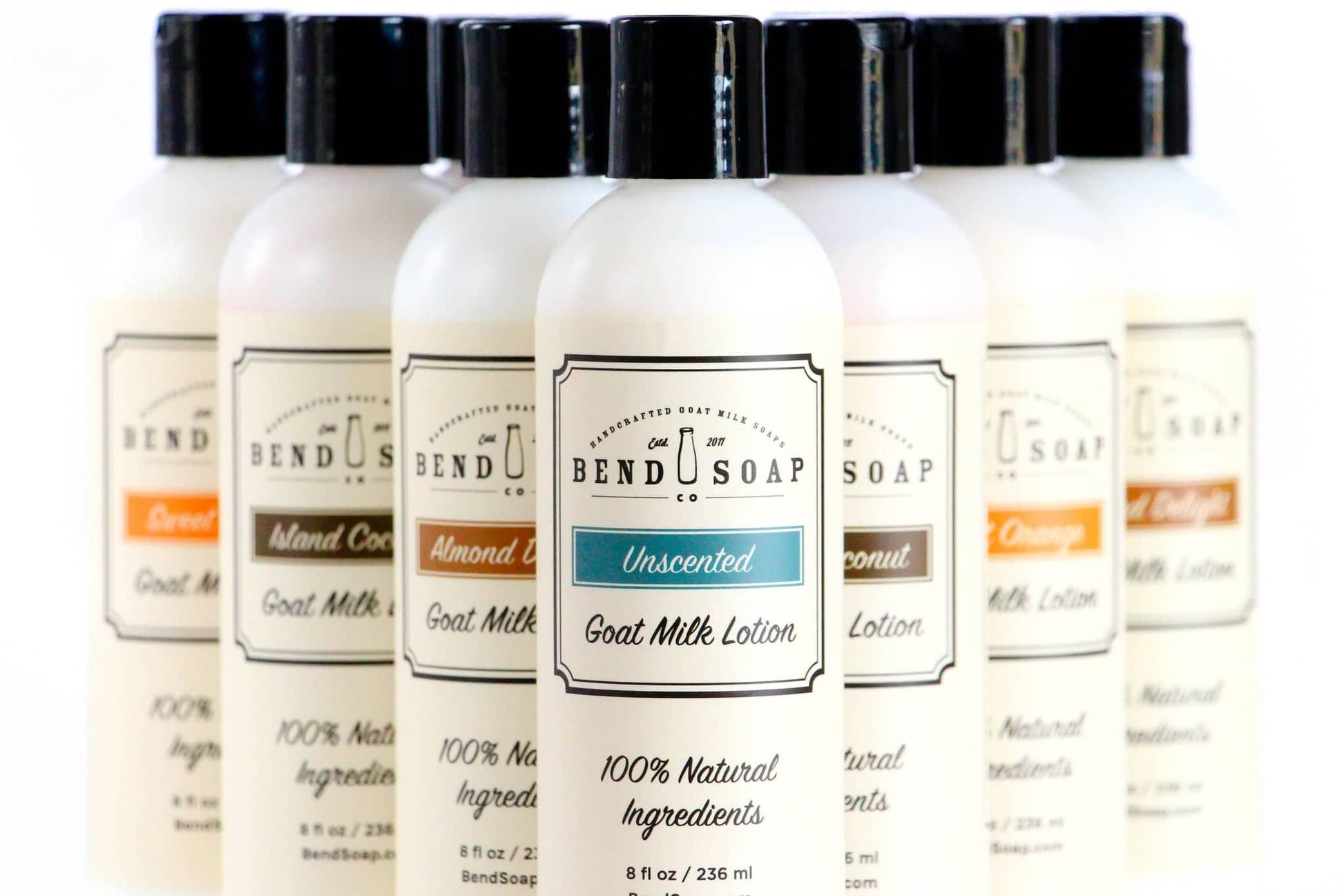 All-Natural and Organic Goat Milk Lotions lined up in a "V" to display the scents.