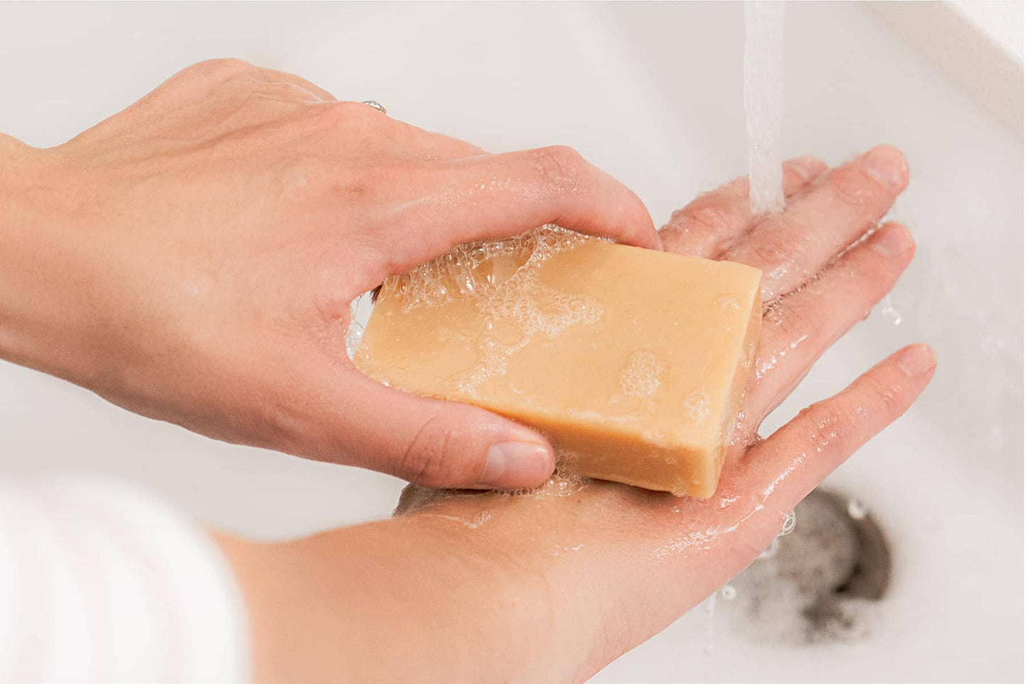 Woman washing hands with unscented goat milk soap 