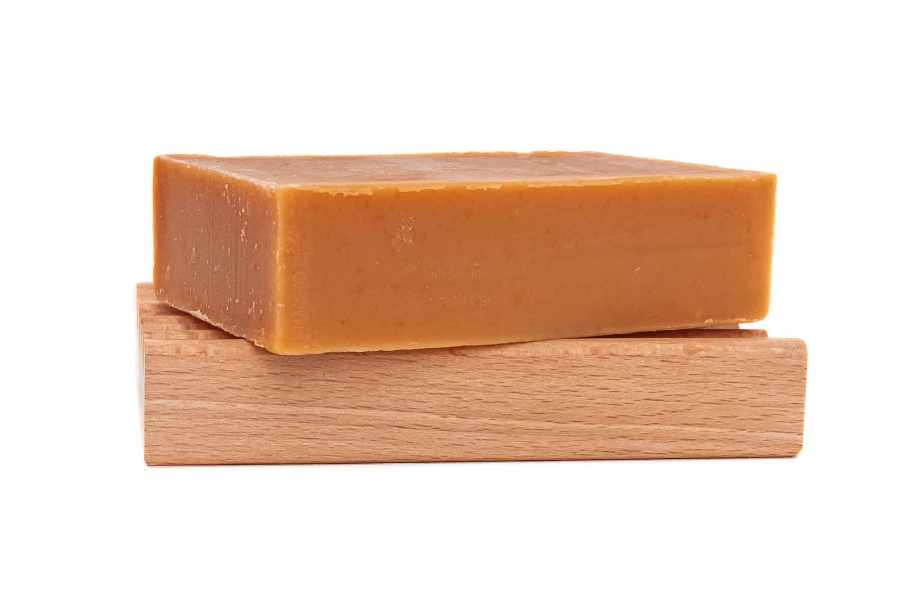 Unwrapped Full Size All Shield bar of soap on a wooden soap dish