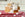 a stack of three bars of chai tea goat milk soap covered in soap suds