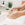 A woman's hands covered in soap suds from goat milk soap